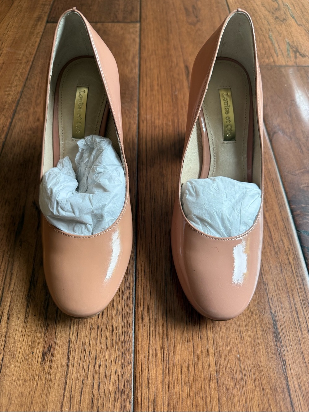 patent leather pumps by Louise et Cie with a glossy finish and rounded toes.